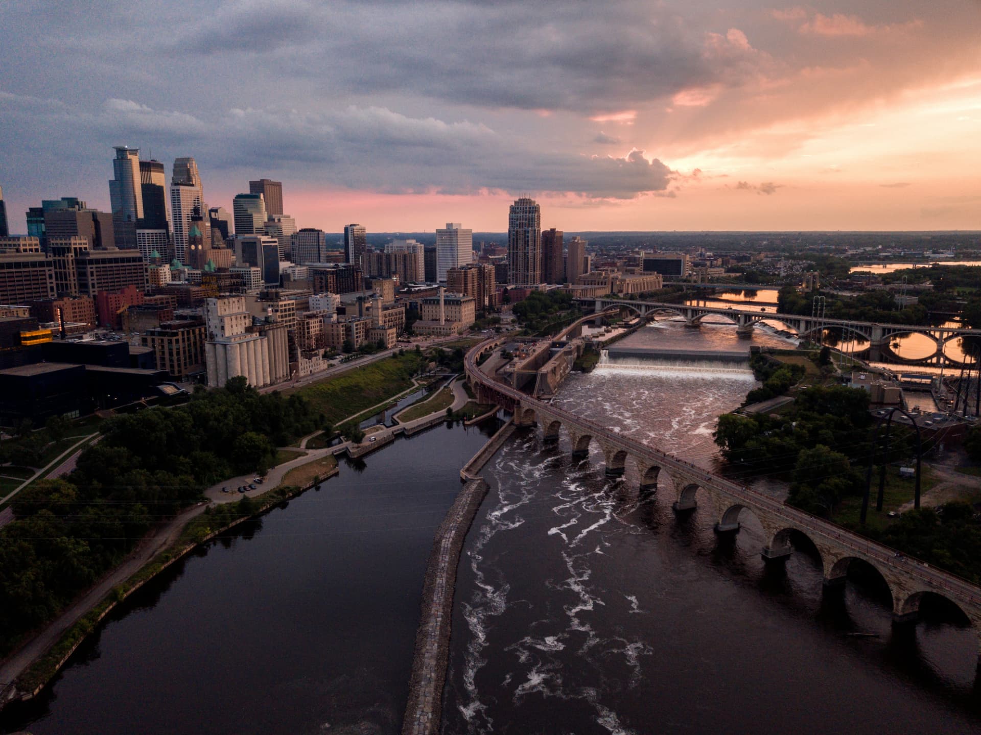 Minneapolis skyline and Stone Arch Bridge at sunset